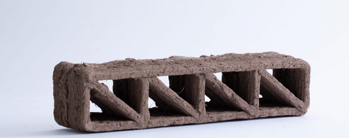 Sistema de refuerzo de fibras continuas para impresión 3D robotizada de arquitectura en tierra